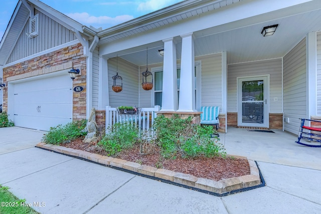 property entrance featuring concrete driveway, stone siding, an attached garage, covered porch, and board and batten siding