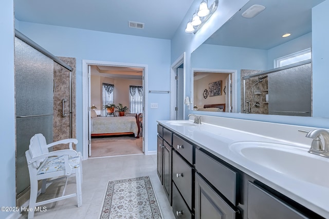 full bath with double vanity, ensuite bath, visible vents, and a sink