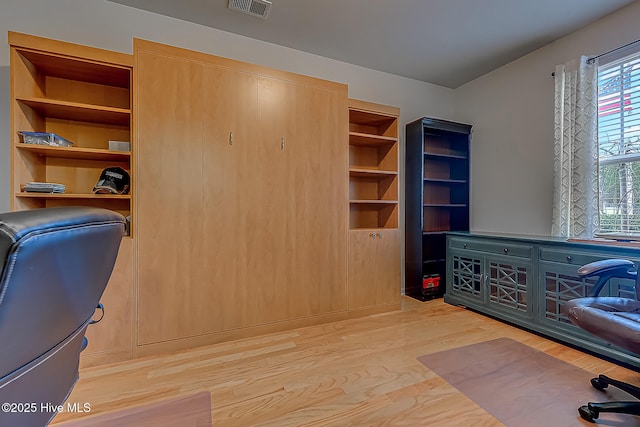 office featuring light wood finished floors and visible vents