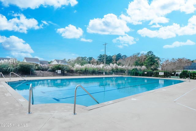 view of pool featuring fence