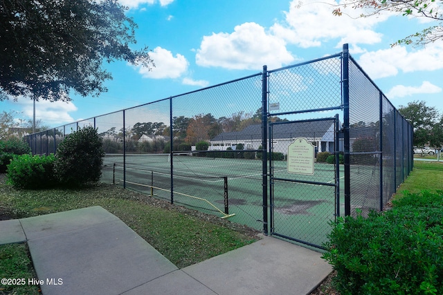 view of sport court with a gate and fence