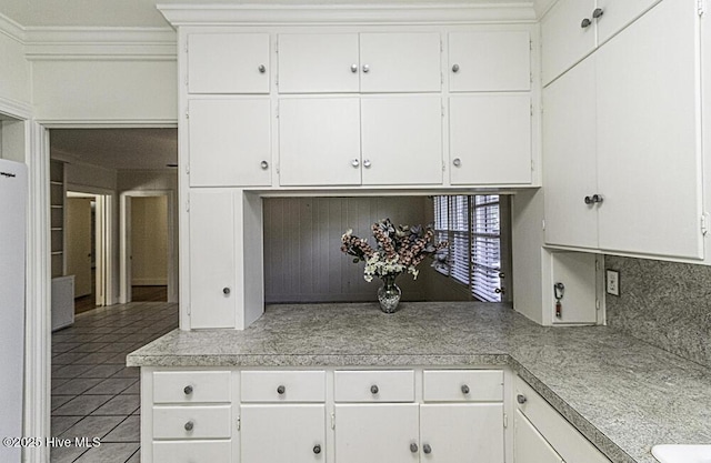 kitchen featuring light countertops, light tile patterned flooring, and white cabinets