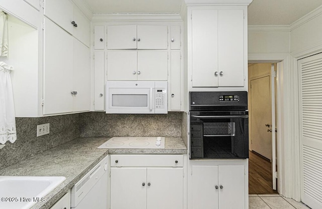 kitchen featuring crown molding, backsplash, white cabinetry, light tile patterned flooring, and white appliances