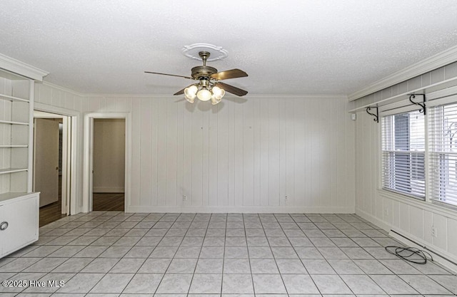 empty room featuring ornamental molding, a textured ceiling, and a ceiling fan