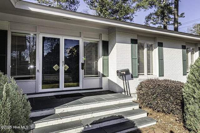 property entrance with brick siding