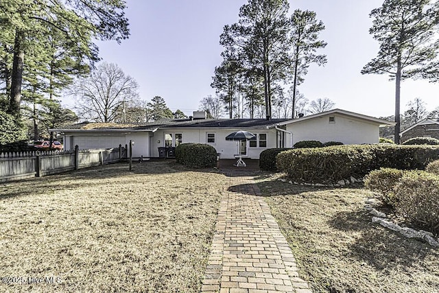 rear view of property featuring fence