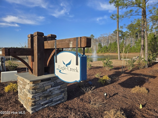 community / neighborhood sign with a water view