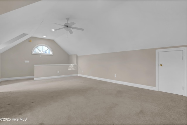 bonus room featuring baseboards, vaulted ceiling, and light colored carpet