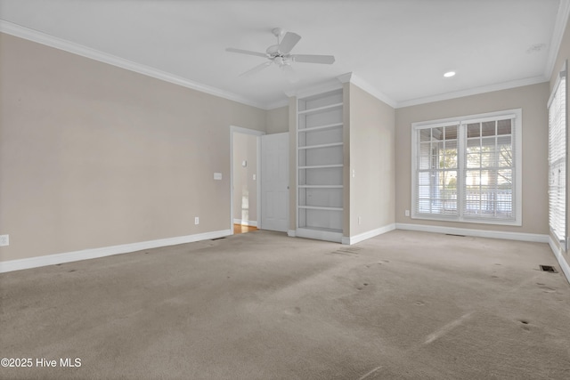 interior space with ornamental molding, light colored carpet, visible vents, and baseboards