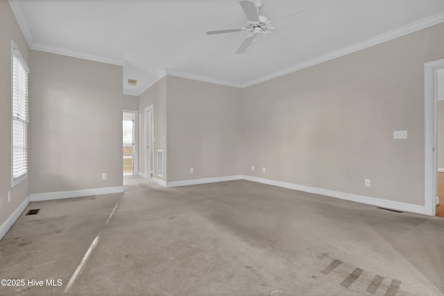 unfurnished room with visible vents, ornamental molding, baseboards, and light colored carpet