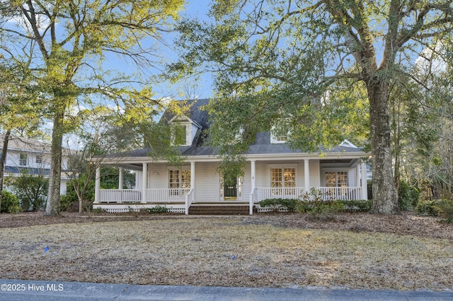 view of front of house with covered porch and a shingled roof