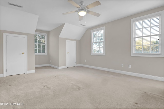 bonus room with visible vents, a wealth of natural light, and light colored carpet