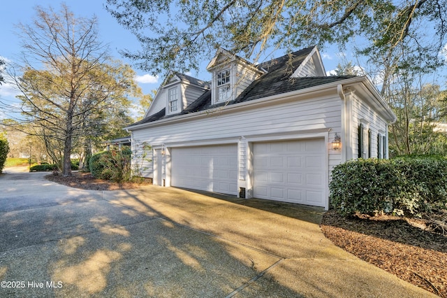 view of home's exterior featuring a garage and concrete driveway