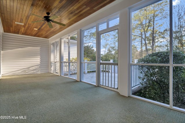 unfurnished sunroom with wooden ceiling and a ceiling fan