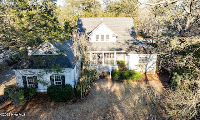 cape cod-style house featuring a shingled roof