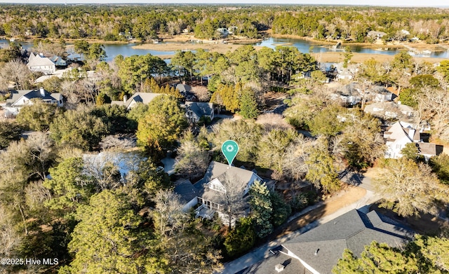 aerial view with a water view and a wooded view