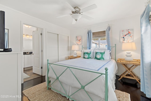 bedroom featuring ornamental molding, a closet, ceiling fan, and wood finished floors