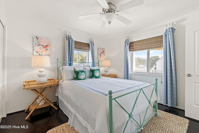 bedroom featuring ceiling fan, ornamental molding, and wood finished floors