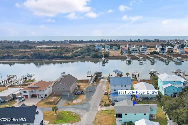 bird's eye view featuring a water view and a residential view