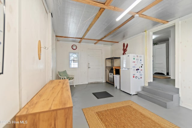 foyer entrance featuring finished concrete flooring