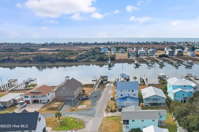 drone / aerial view featuring a residential view and a water view