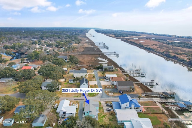 drone / aerial view featuring a water view and a residential view