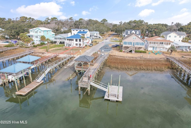 birds eye view of property featuring a water view and a residential view