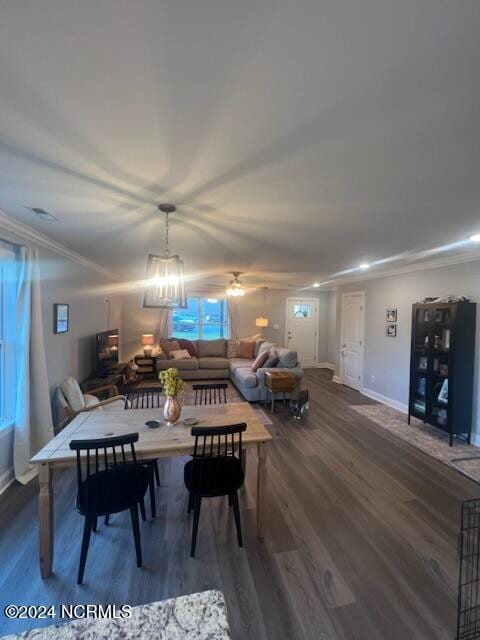 dining area featuring baseboards, visible vents, ceiling fan, ornamental molding, and dark wood-type flooring