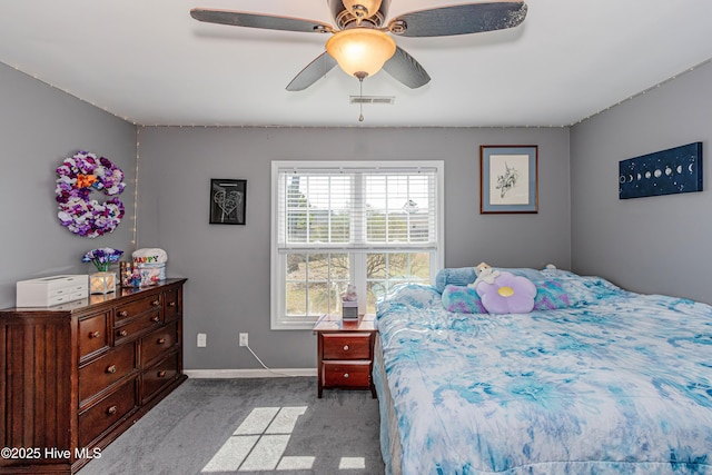 carpeted bedroom with visible vents, baseboards, and ceiling fan