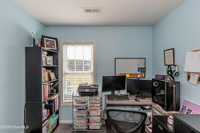 office space with visible vents and baseboards