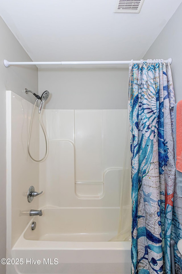 full bath featuring visible vents and shower / tub combo with curtain