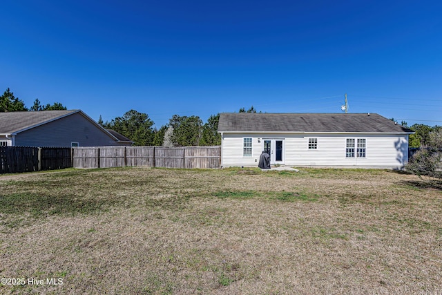 back of house with a yard and fence private yard