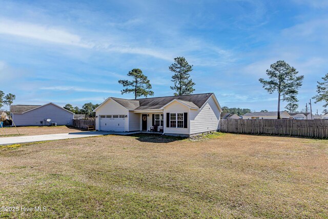 single story home featuring a front lawn, an attached garage, fence, and driveway