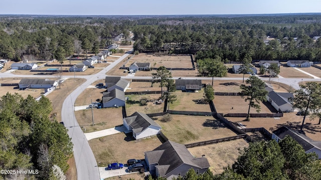 birds eye view of property with a view of trees