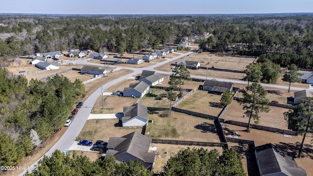 birds eye view of property featuring a forest view