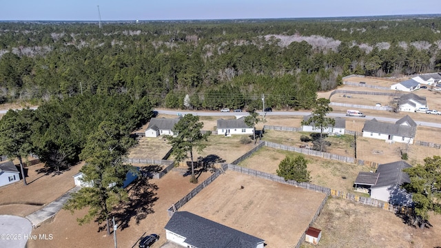 birds eye view of property with a view of trees