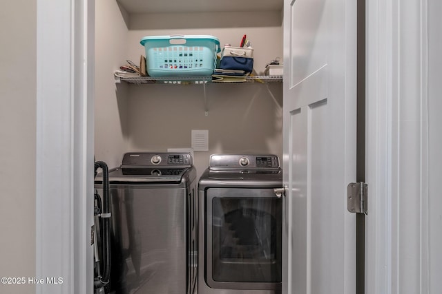 washroom with laundry area and washer and dryer