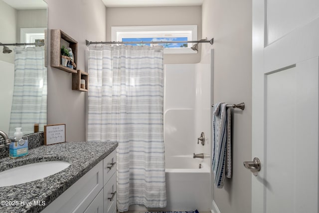 full bathroom featuring shower / bath combo with shower curtain and vanity