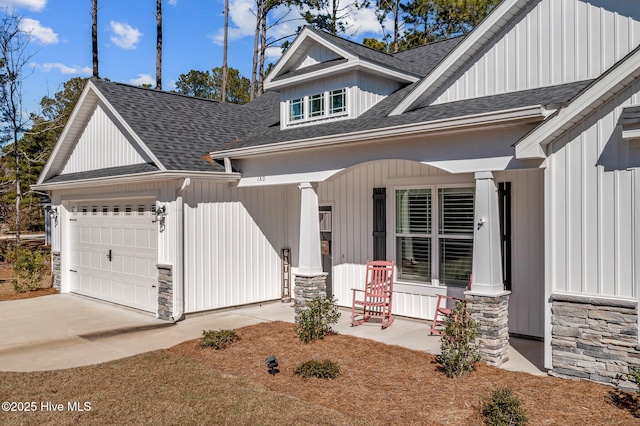 modern farmhouse style home featuring an attached garage, stone siding, a porch, and a shingled roof