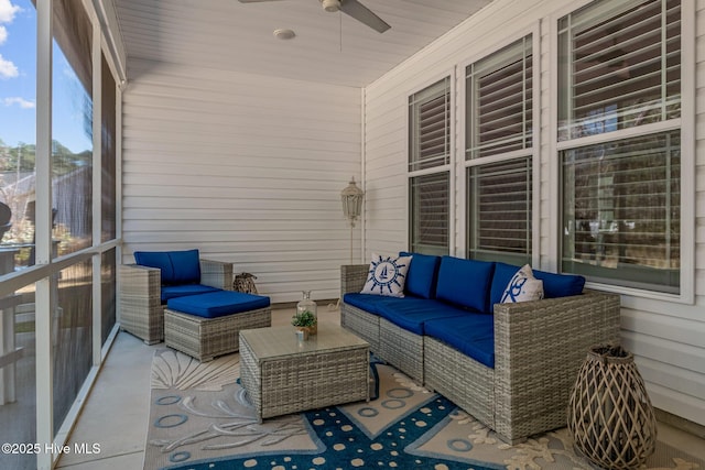 sunroom / solarium featuring a ceiling fan