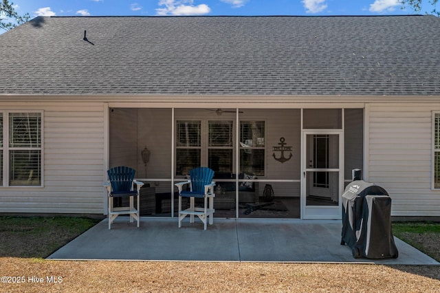 rear view of house featuring a shingled roof, a patio area, and ceiling fan