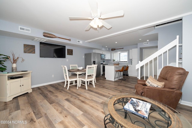 dining room featuring light wood-style flooring, visible vents, and baseboards