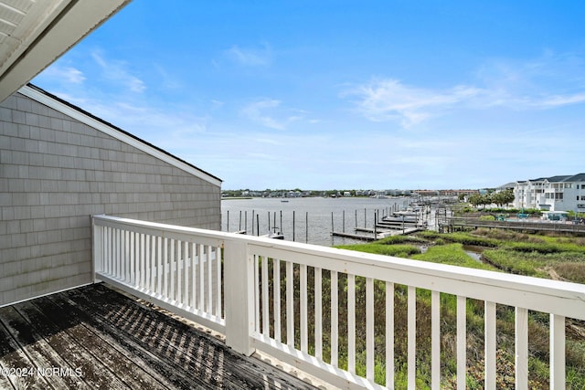 wooden deck featuring a water view and a dock