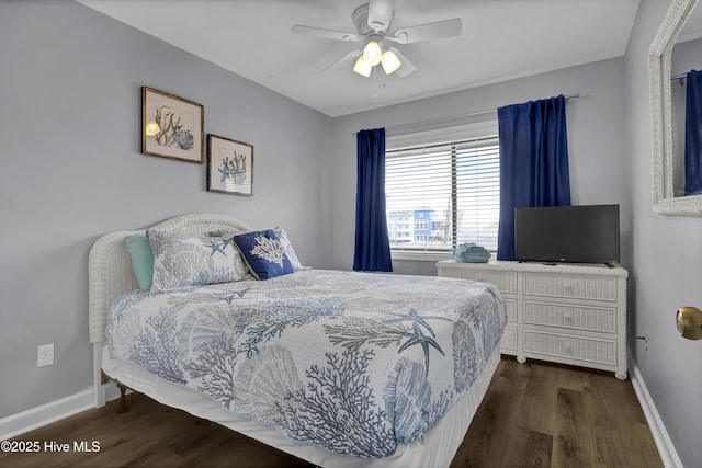 bedroom with a ceiling fan, baseboards, and wood finished floors