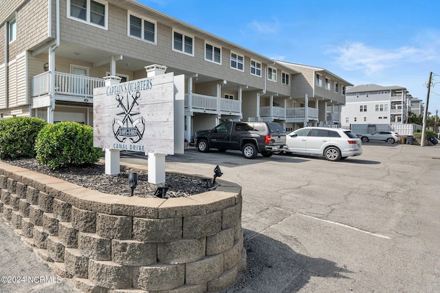 exterior space featuring uncovered parking and a residential view