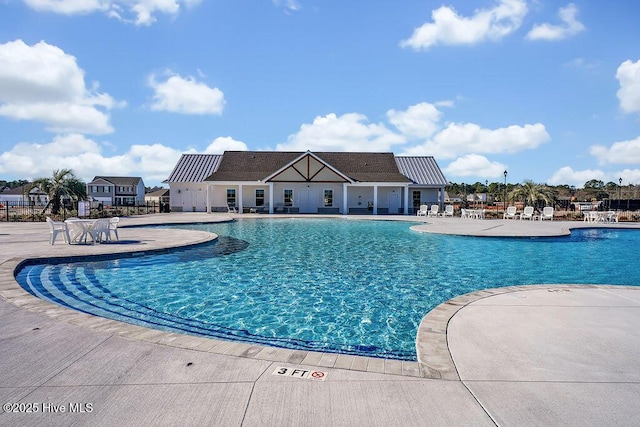 community pool featuring a patio area and fence