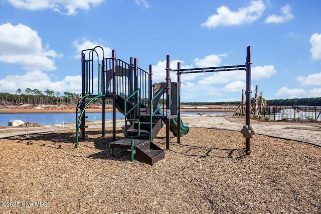 community play area featuring a water view and fence