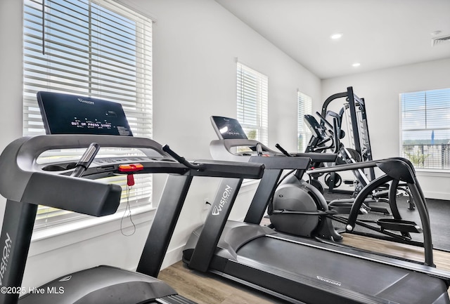 workout area featuring baseboards, wood finished floors, and recessed lighting