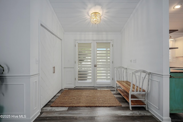 entryway featuring a decorative wall, dark wood-style flooring, french doors, wainscoting, and crown molding