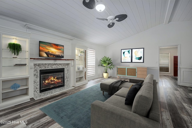 living area with lofted ceiling, wood ceiling, wood finished floors, and a tile fireplace